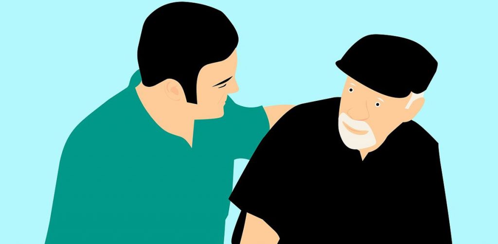 Pfleger hilft pflegebedürftigem Mann